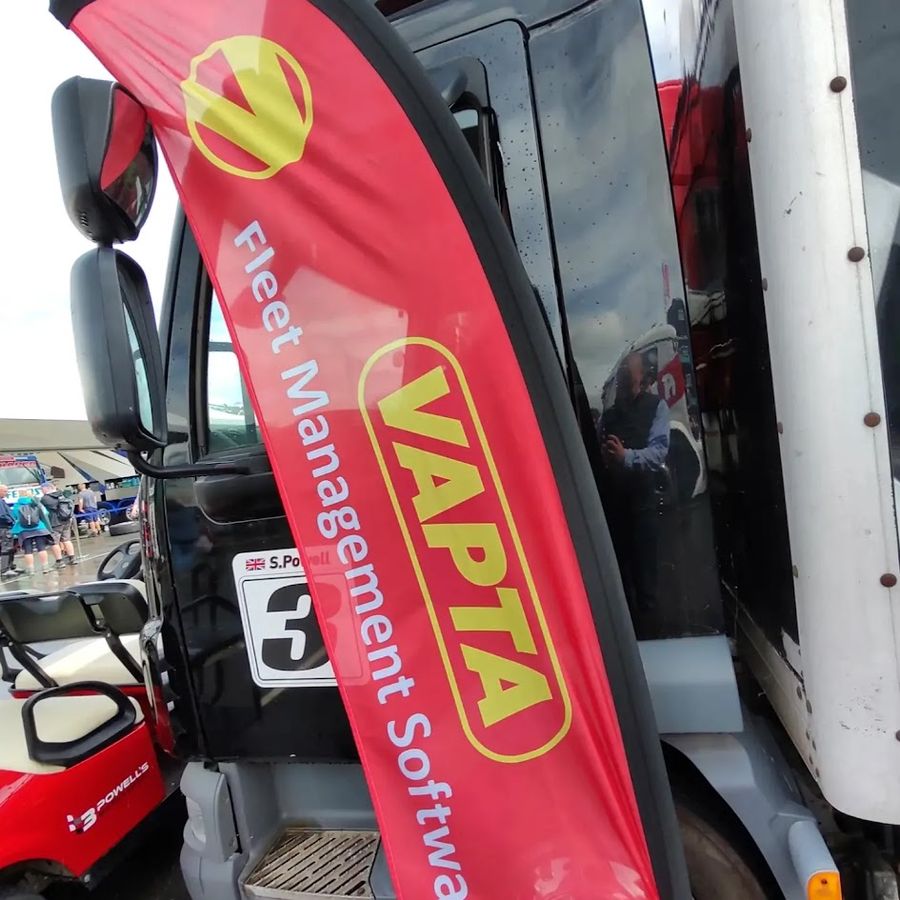 VAPTA Fleet Management Software flag beside a race truck in the paddock